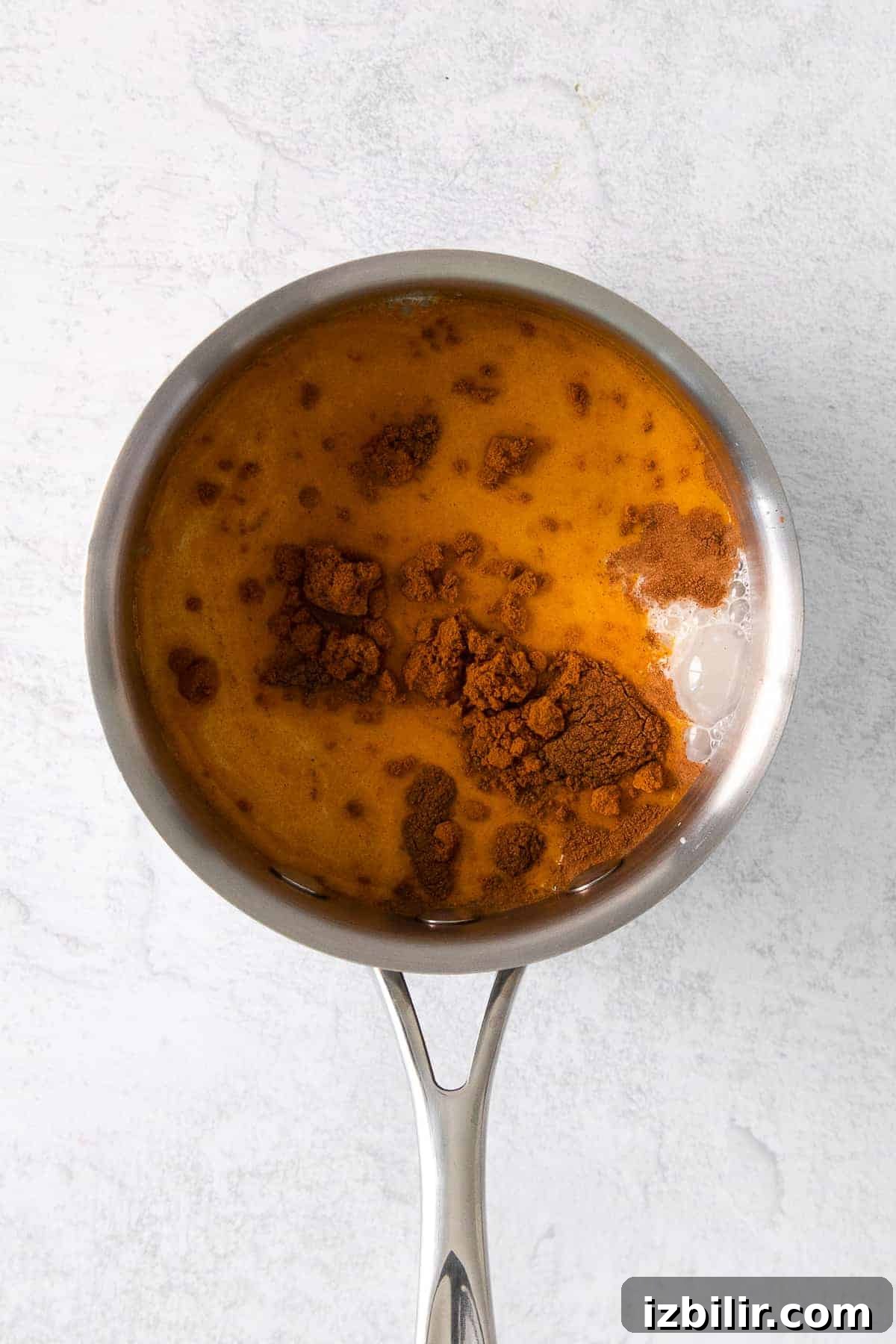 golden milk latte being poured from a pot