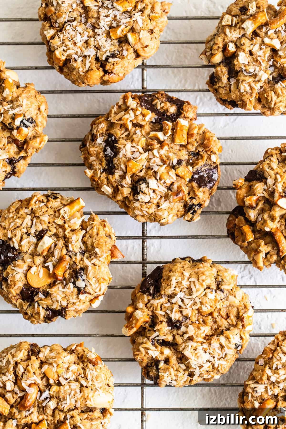 These kitchen sink cookies truly are everything but the kitchen sink! You'll absolutely love these salty, sweet and chewy cookies. kitchen sink cookies on a cooling rack