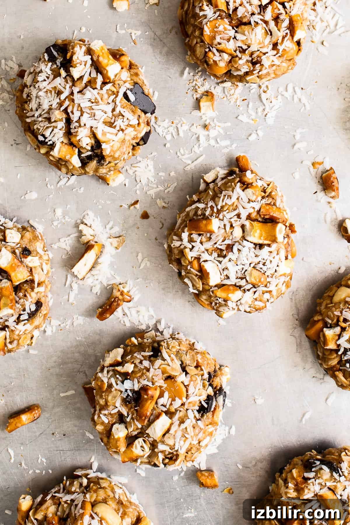 Cookies topped with coconut kitchen sink cookies on a baking sheet topped with coconut