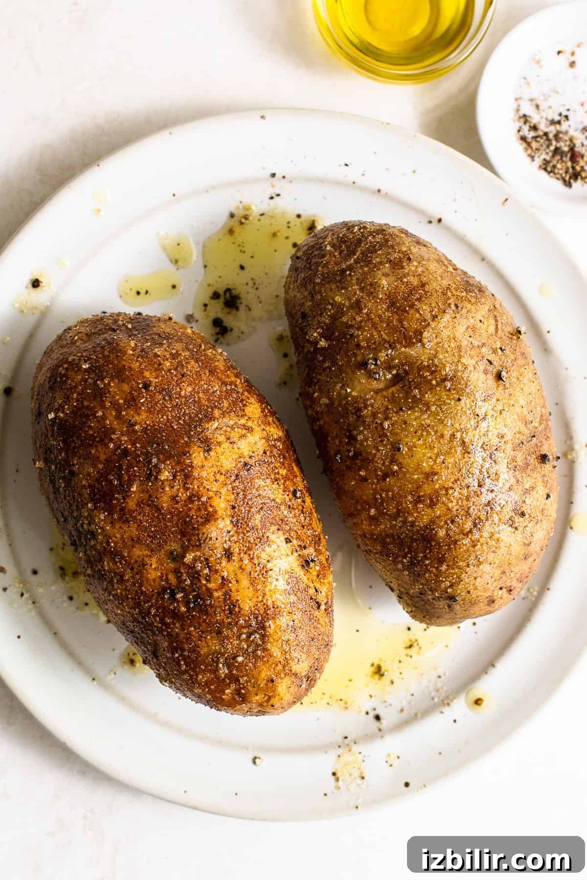 Crispy Air Fryer Baked Potatoes 3 russet potatoes with olive oil, salt, and pepper