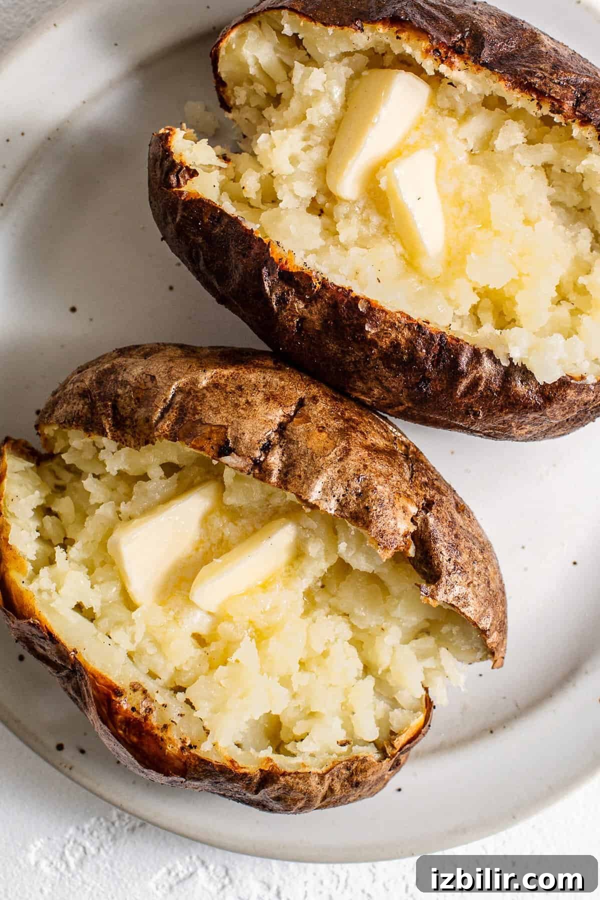 Crispy Air Fryer Baked Potatoes 5 baked potato with butter on top