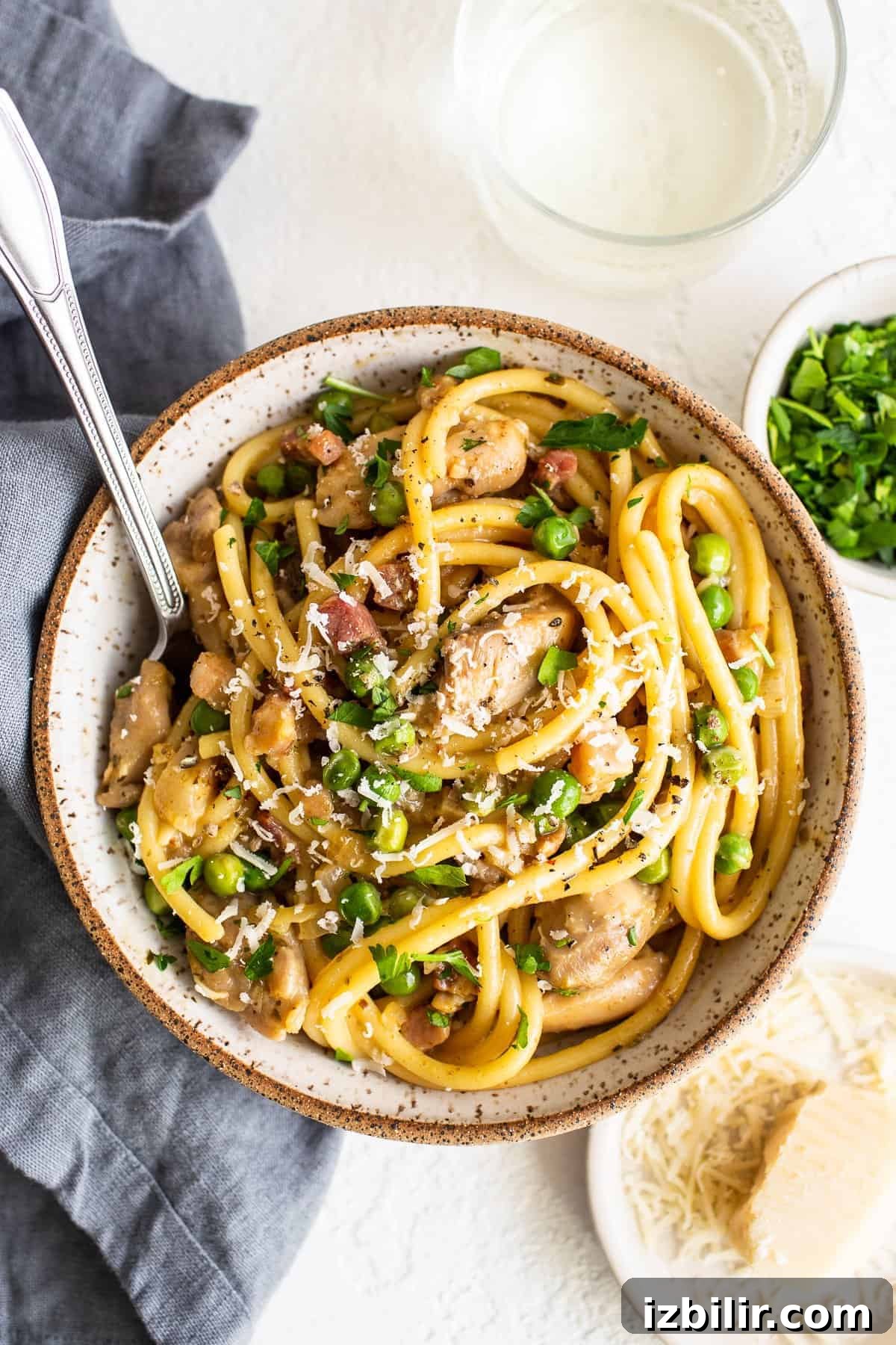 Chicken carbonara in a bowl with a spoon.