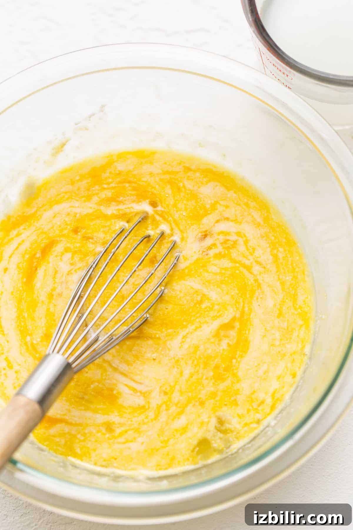 Whisked eggs in a bowl for chicken carbonara.