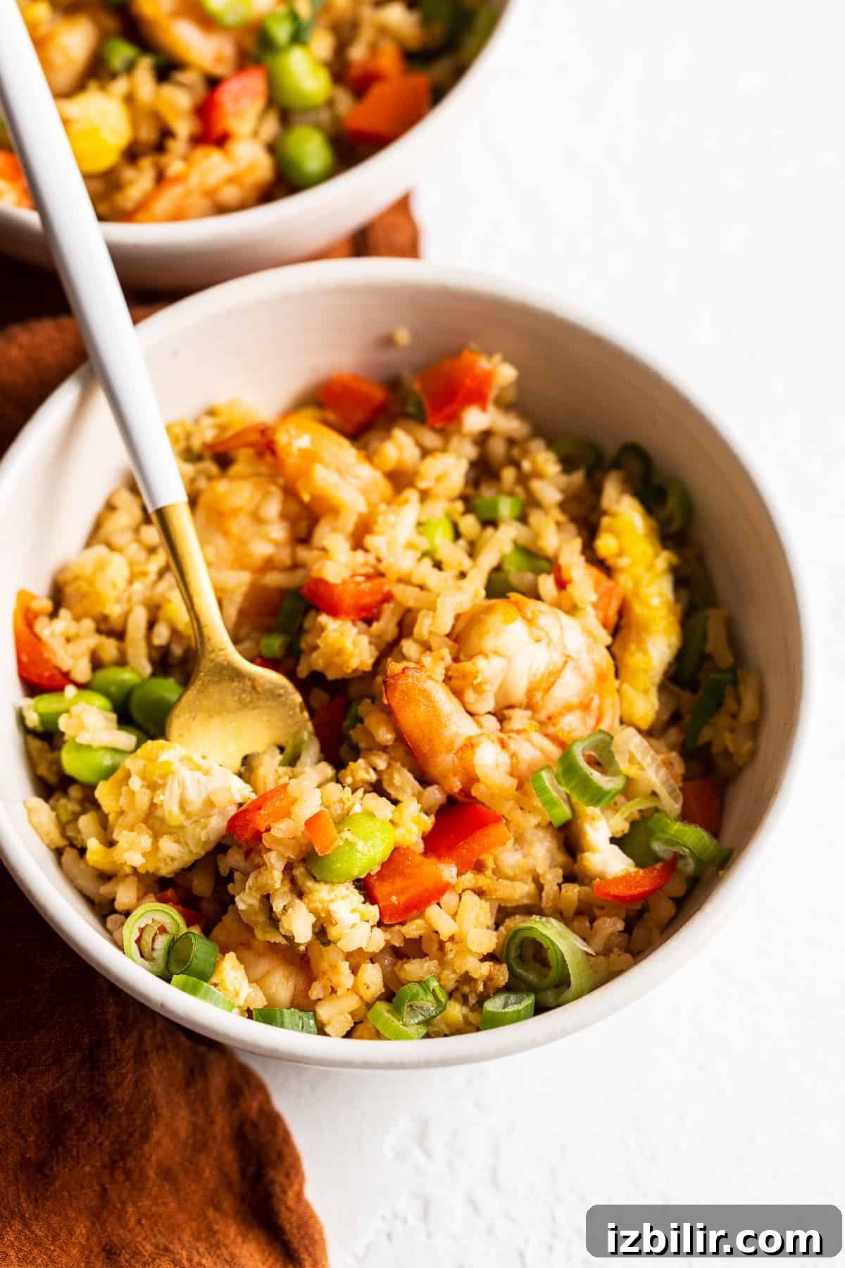 Got leftover white rice? Make shrimp fried rice for a protein and veggie-packed meal ready to go in less than 30 minutes. shrimp fried rice in bowl