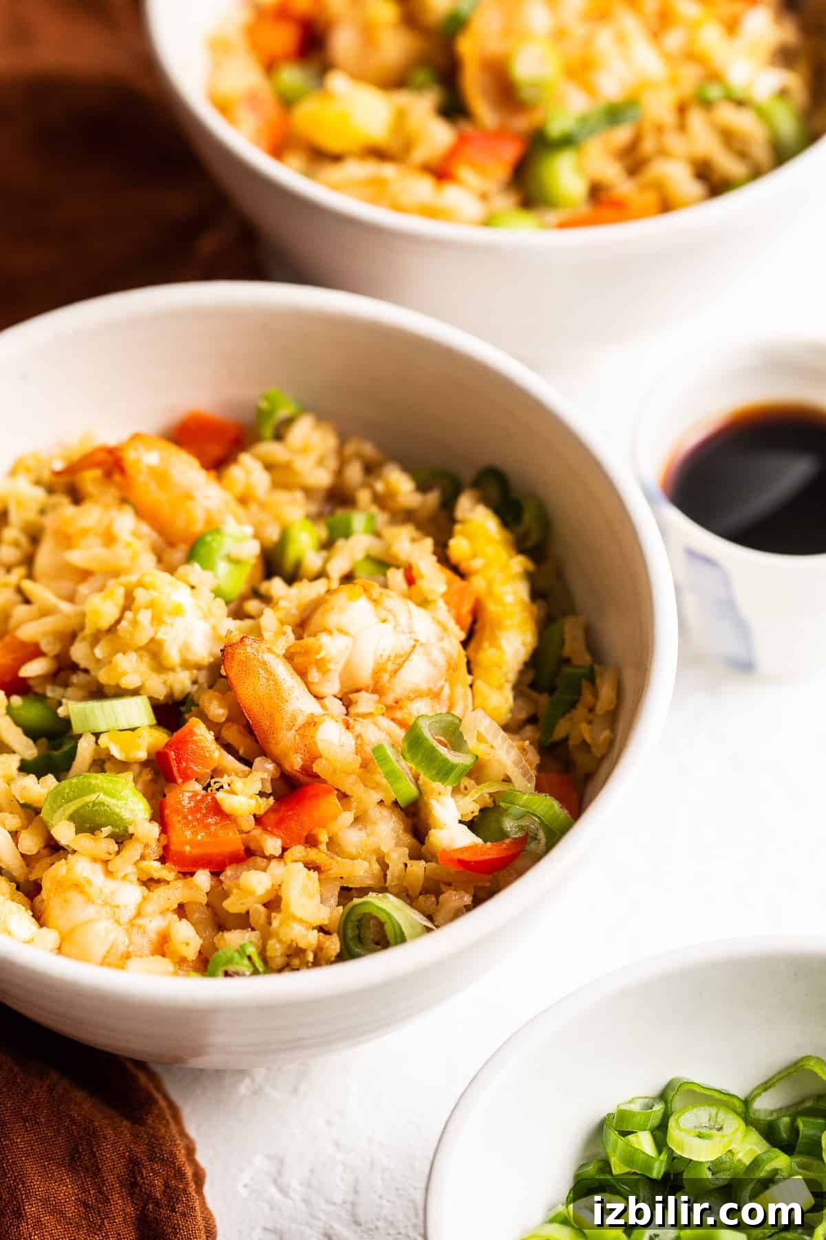 Serve shrimp fried rice with green onions shrimp fried rice in bowl