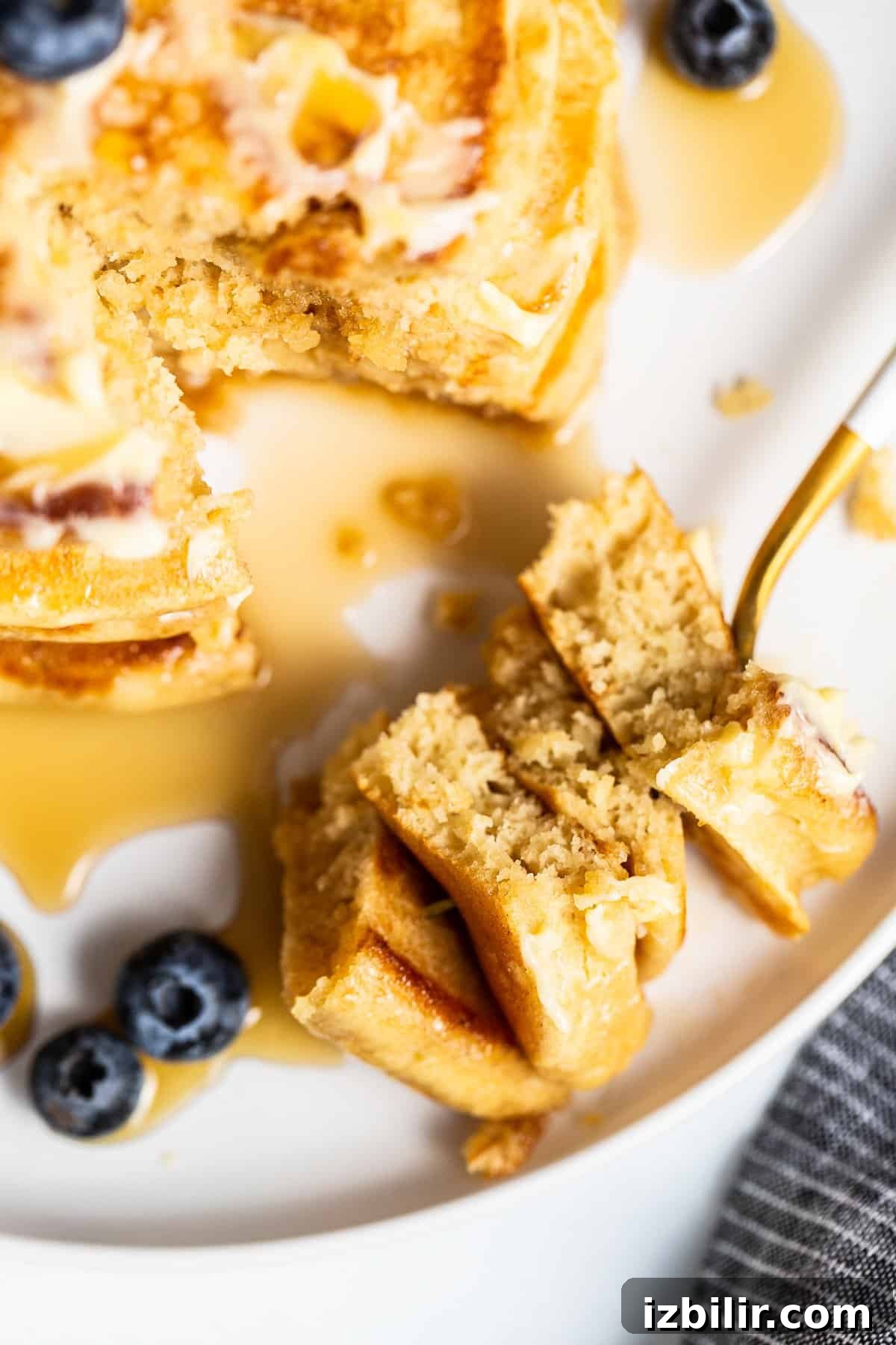 Homemade Fluffy Pancake Recipe for Light, Tender Stacks 8 pancakes on fork