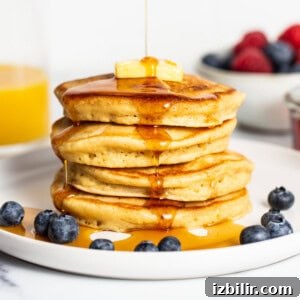 Homemade Fluffy Pancake Recipe for Light, Tender Stacks 9 stack of pancakes with maple syrup