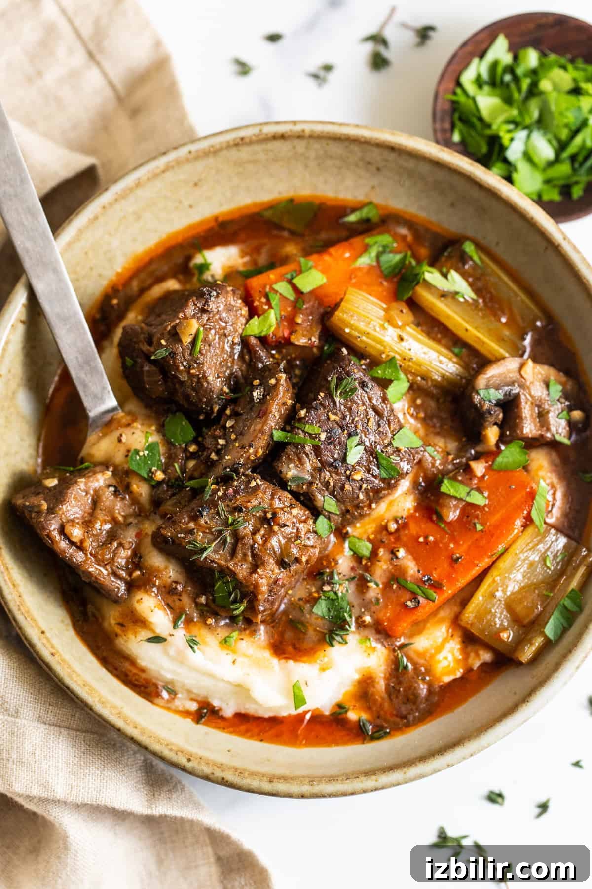 A bowl of Guinness stew served over mashed potatoes.