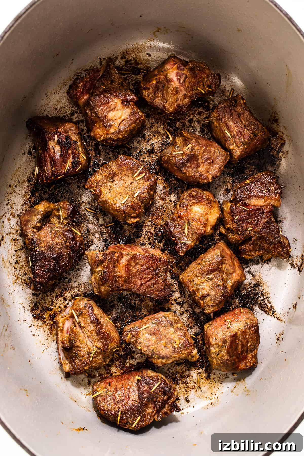 Browned beef chunks in a pot.