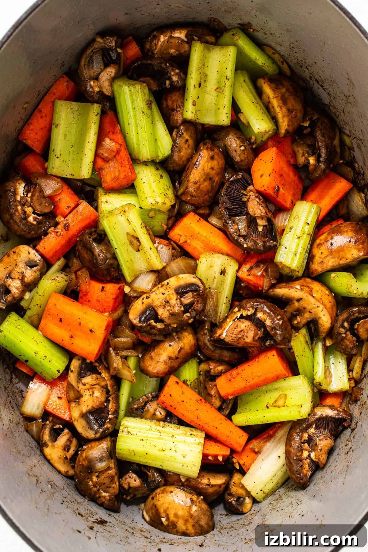Carrots, celery, and mushrooms in a Dutch oven.