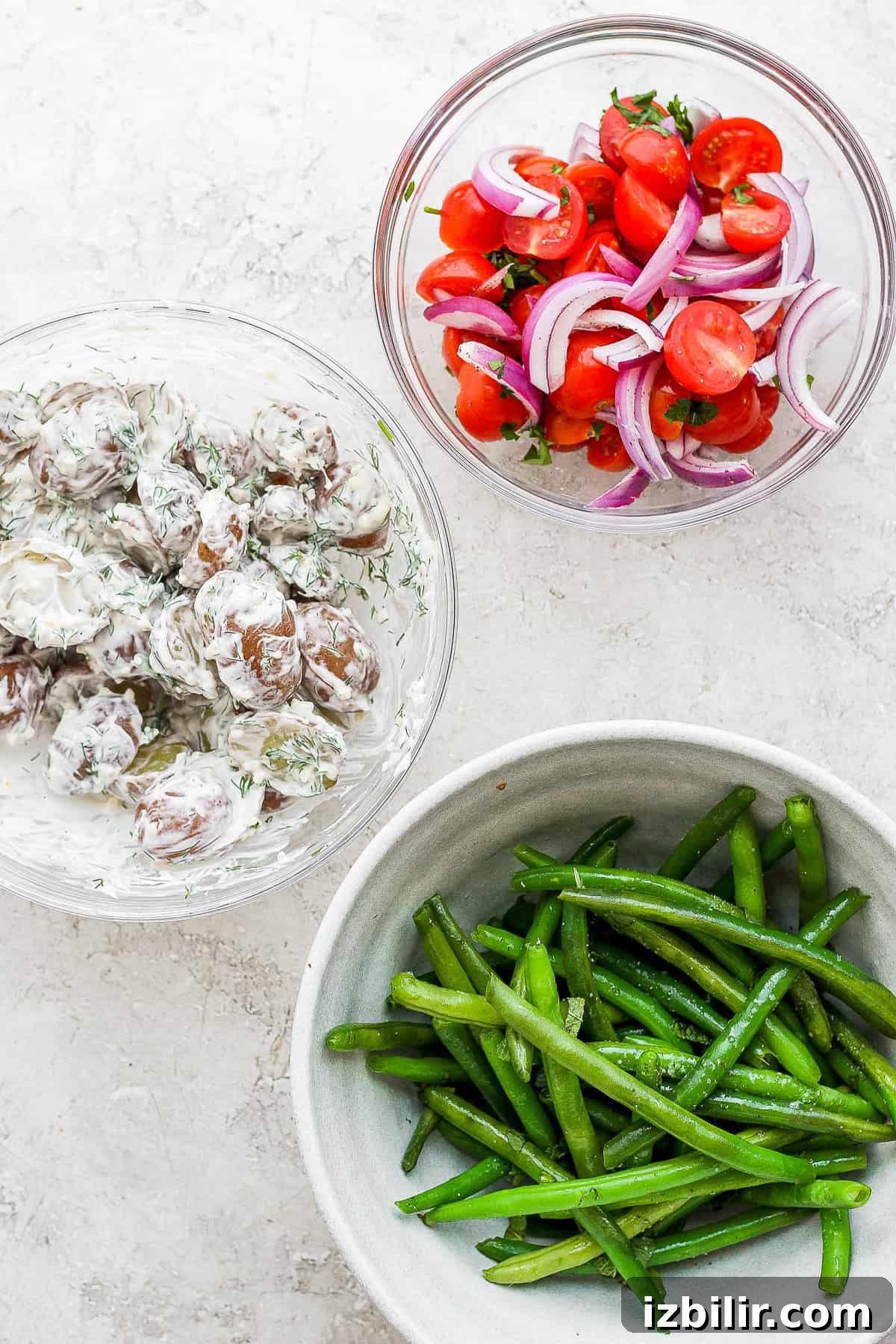 Classic Nicoise Salad Recipe 3 Different ingredients for a Nicoise Salad in bowls.