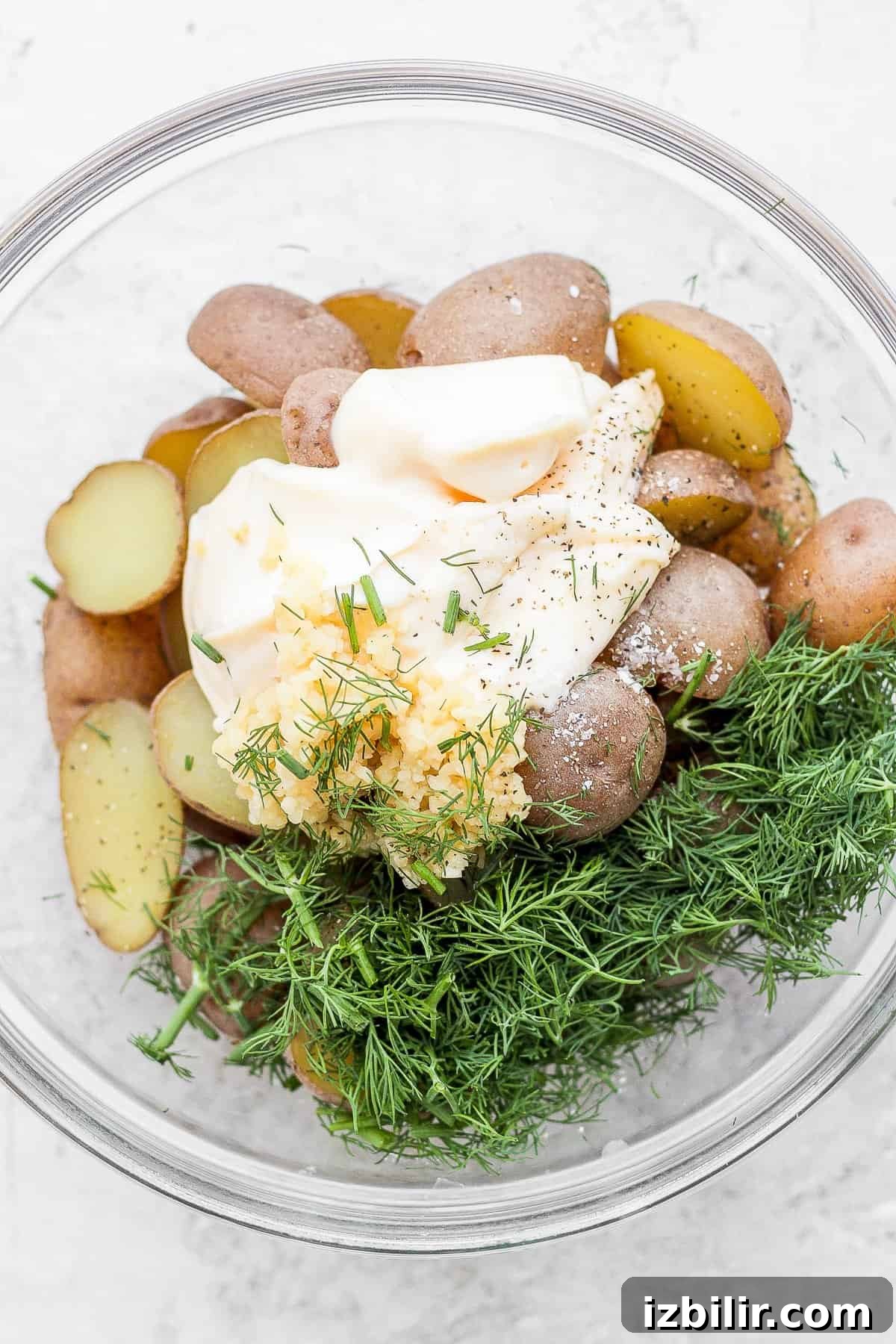Classic Nicoise Salad Recipe 4 Potatoes, mayo, garlic, and fresh dill in a bowl.