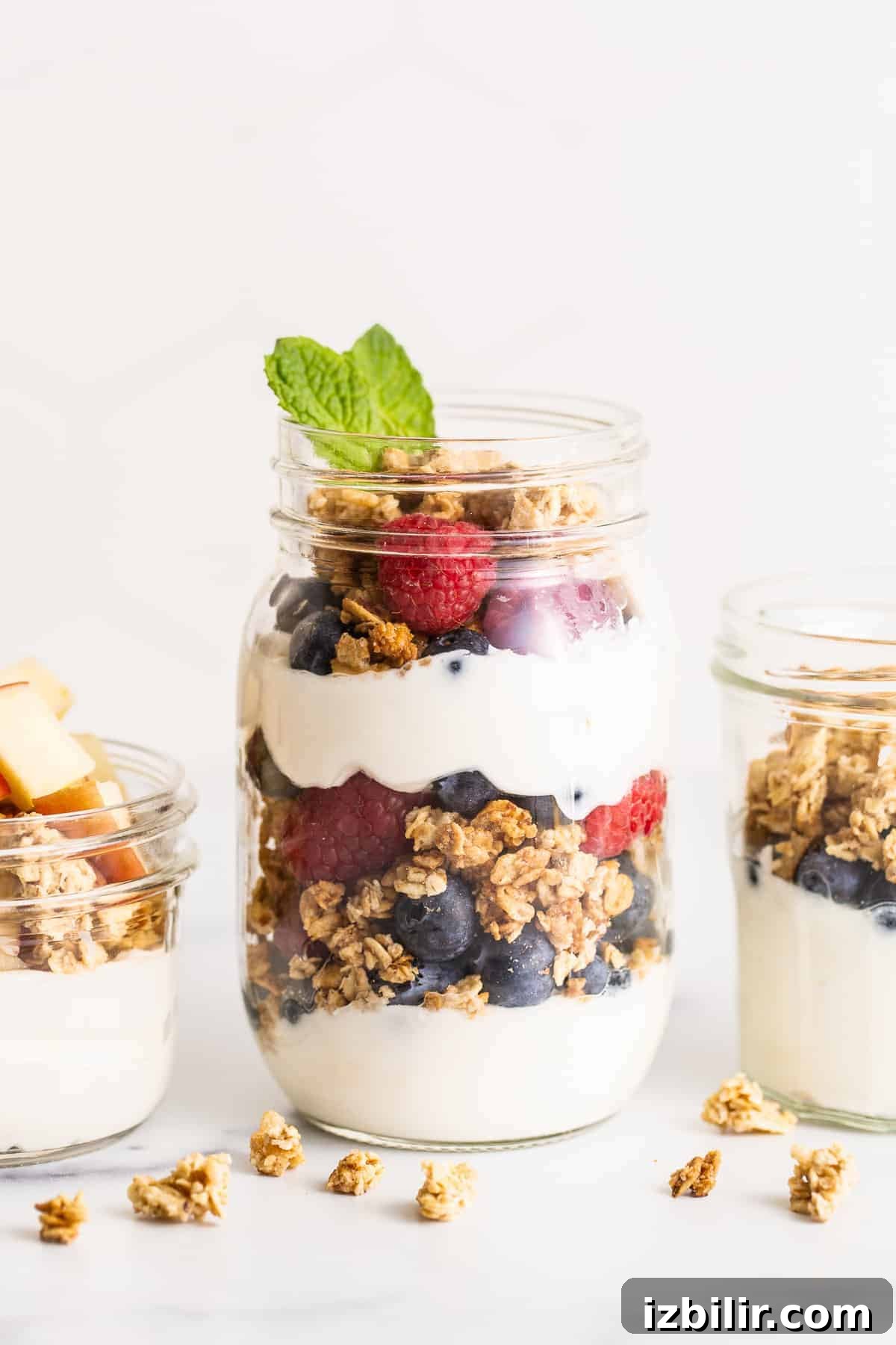 yogurt parfait in a mason jar topped with fresh mint