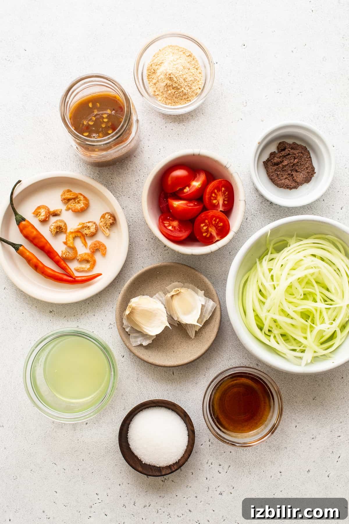 Small bowls with ingredients for papaya salad. Ingredients for papaya salad in small bowls.