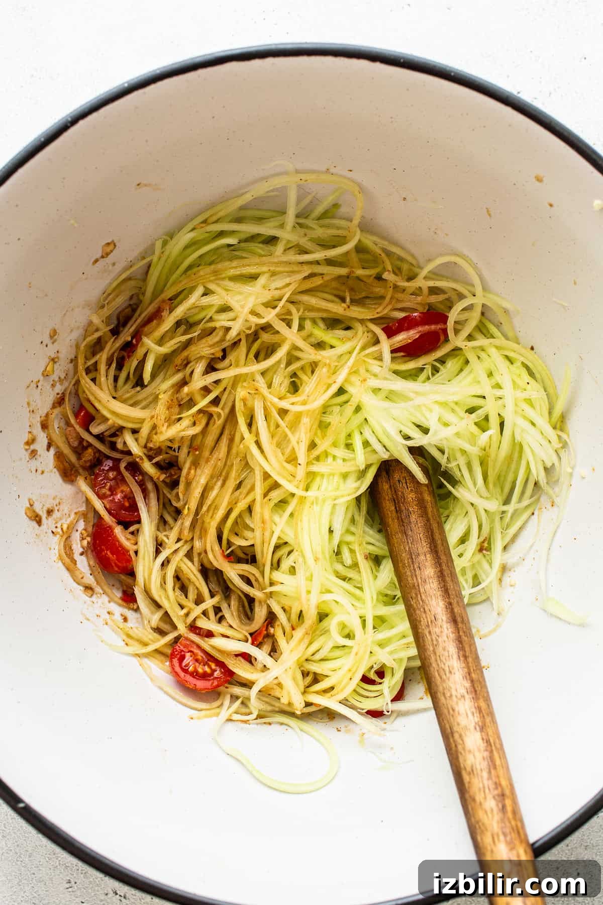 Shredded papaya with cherry tomatoes. Shredded papaya and cherry tomatoes in a bowl.