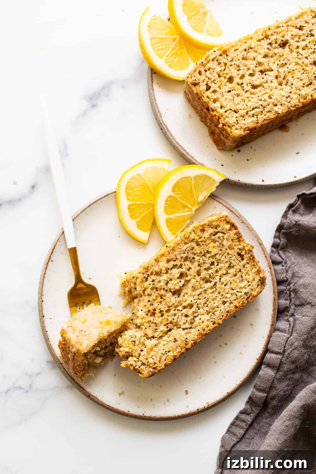 A piece of lemon poppy seed bread on a plate.