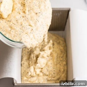 Pour the batter into a lined loaf pan.