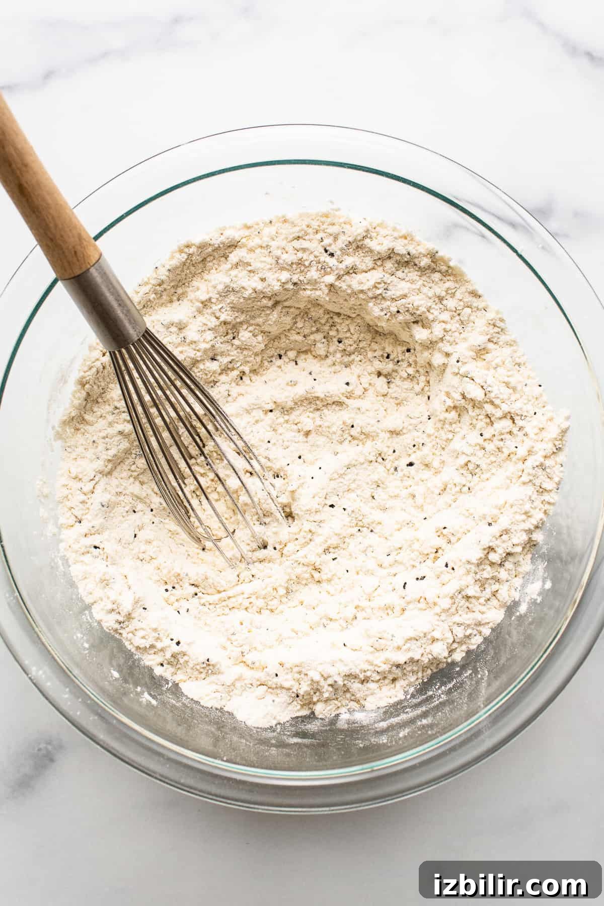 The dry ingredients for lemon poppy seed bread in a bowl.
