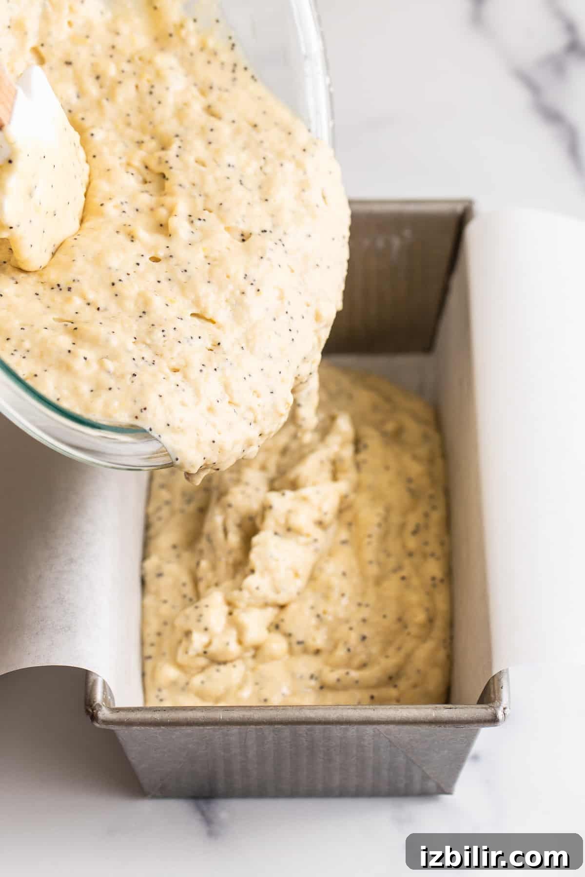 Pour the batter into a lined loaf pan.