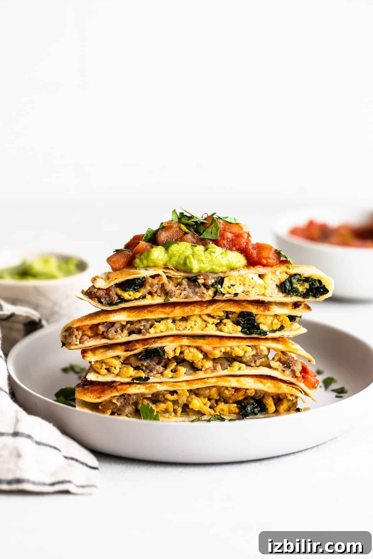 Freezer breakfast quesadillas stacked on a plate.