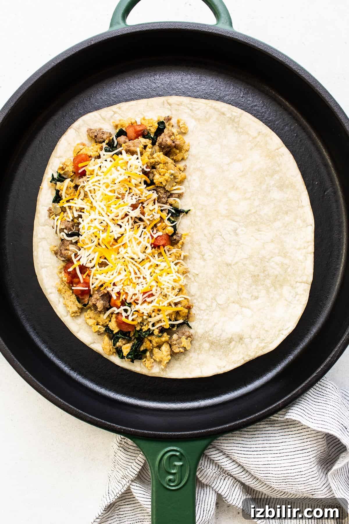 Breakfast quesadilla assembled in a cast iron skillet.