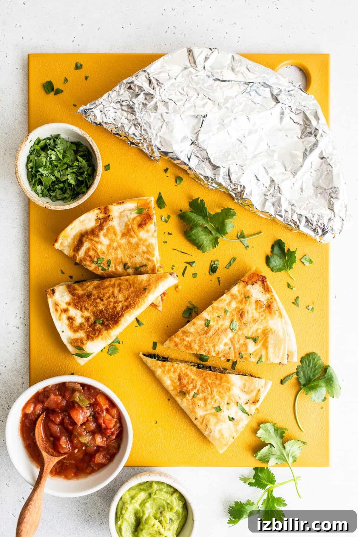 Slices of breakfast quesadillas on a cutting board.