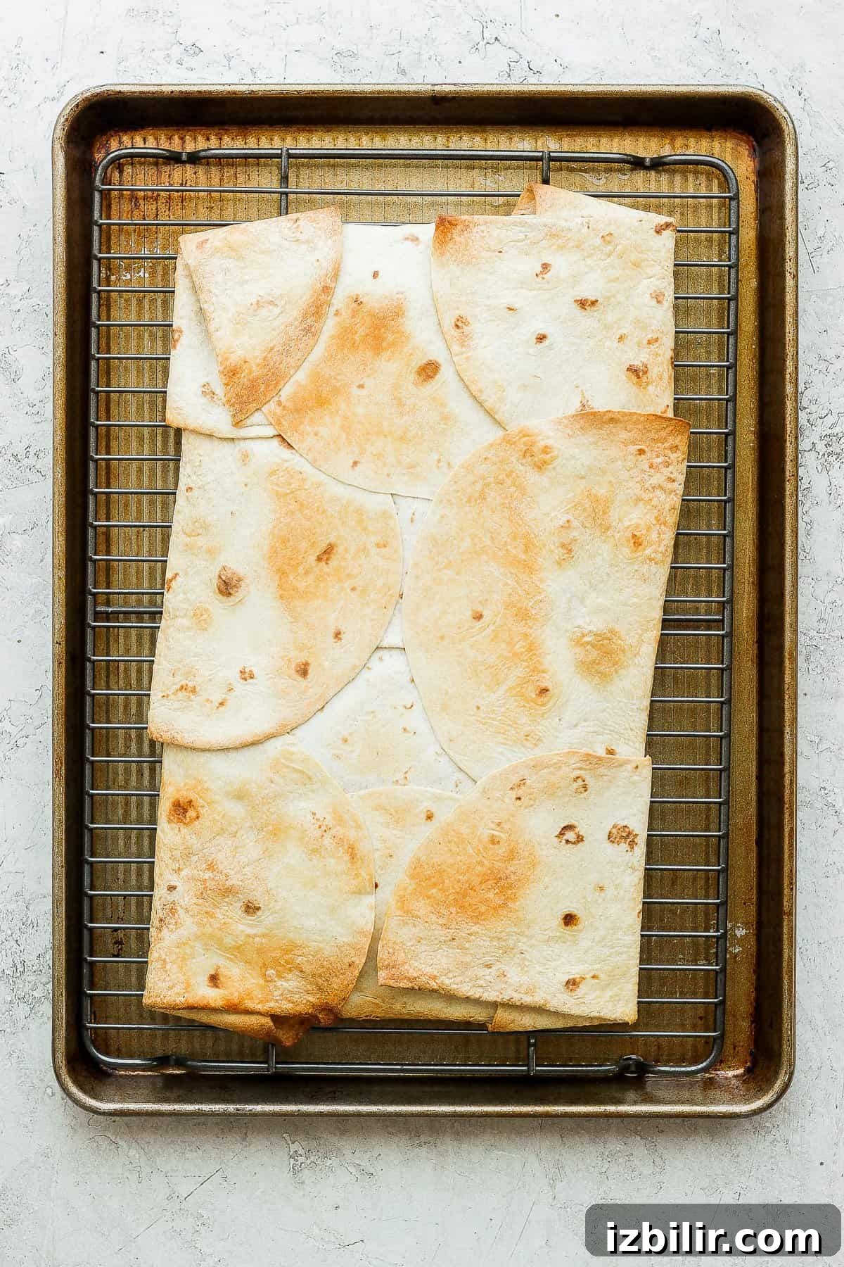 Golden brown quesadillas on a baking sheet.