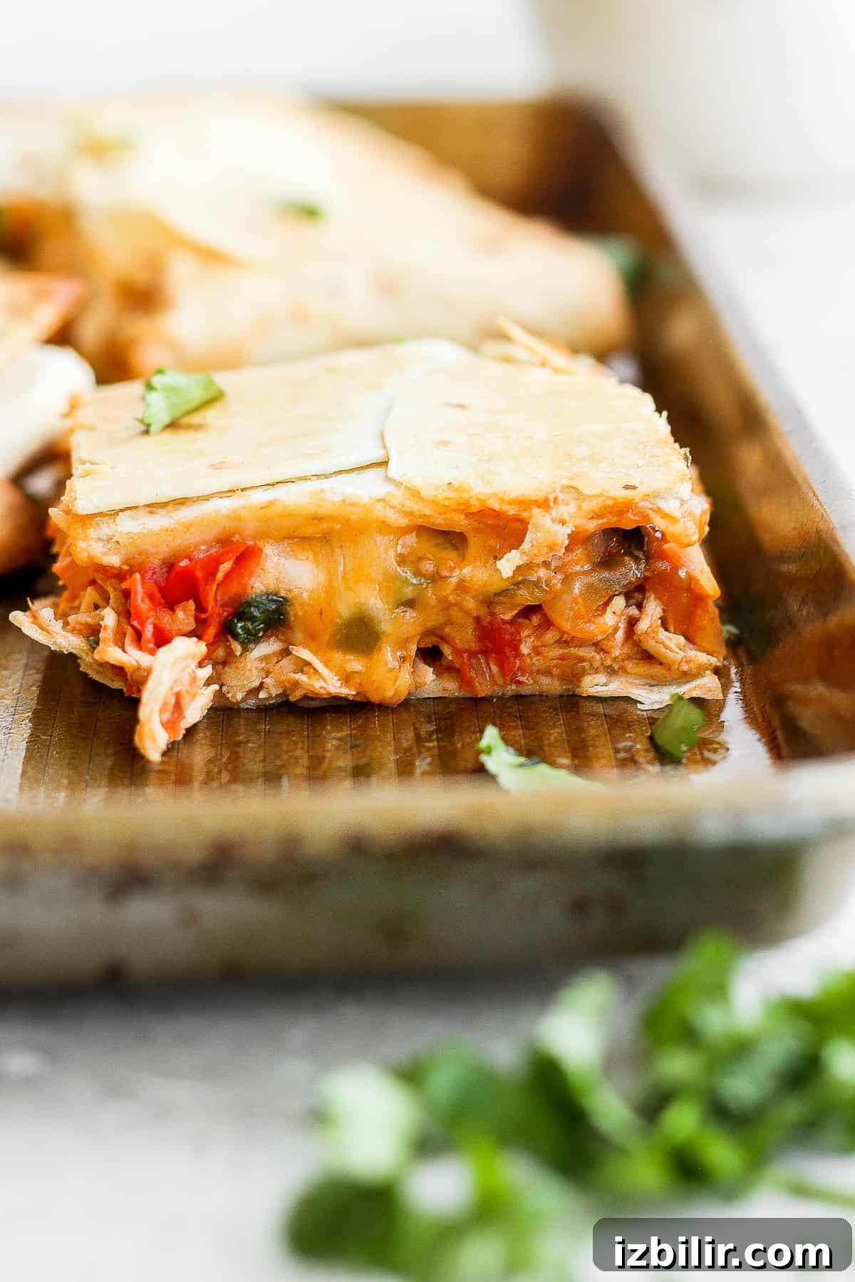 Sheet pan quesadillas with filling and cheese.