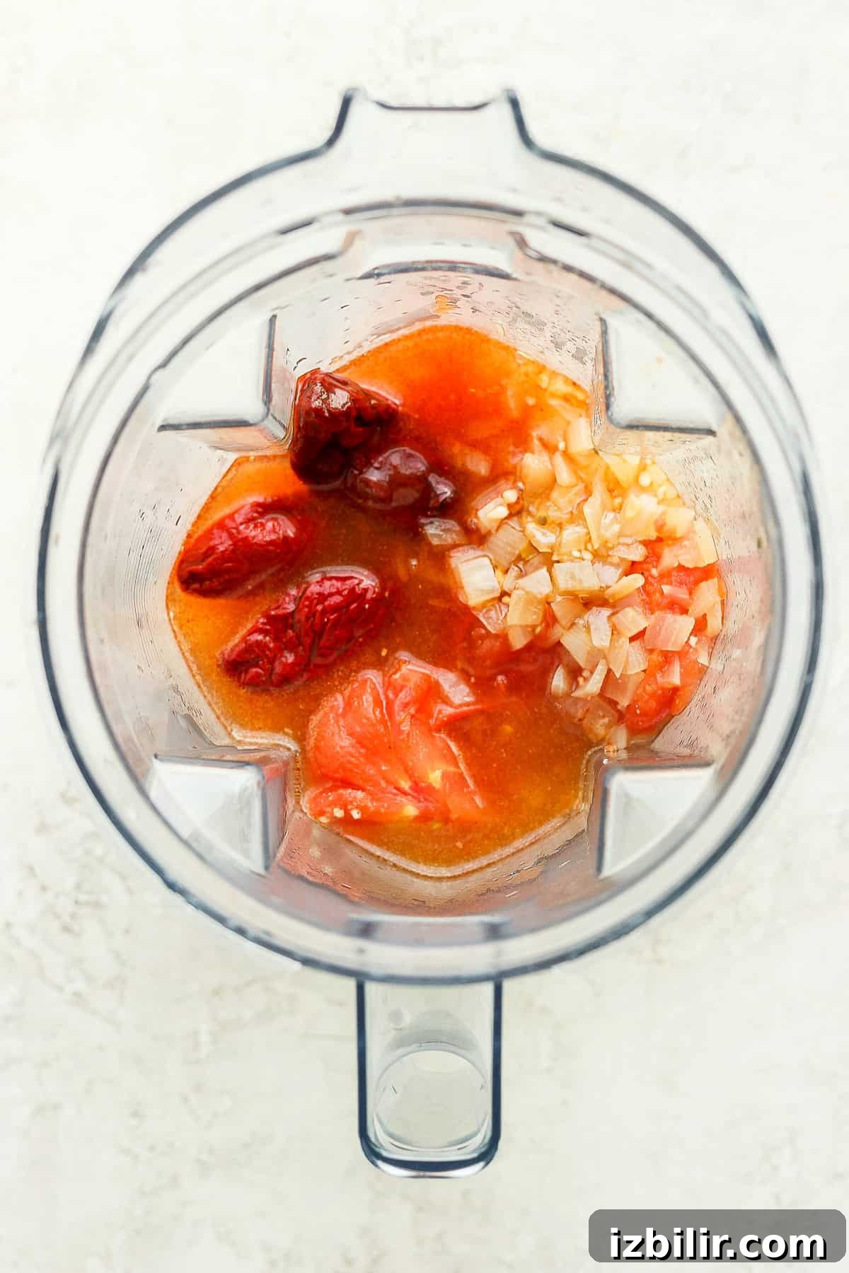 Chicken tinga ingredients in a blender.