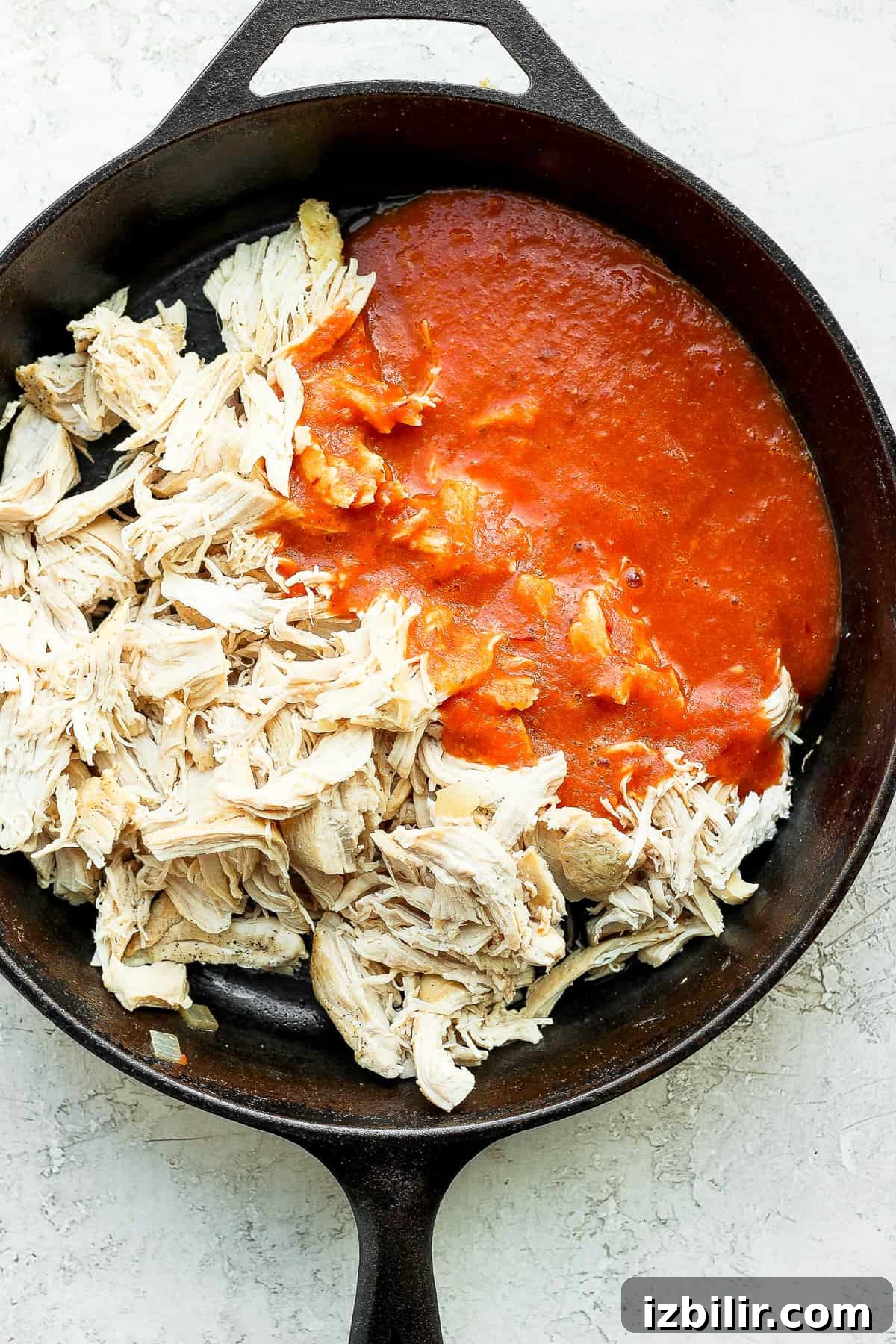 Chicken tinga in a cast iron skillet.