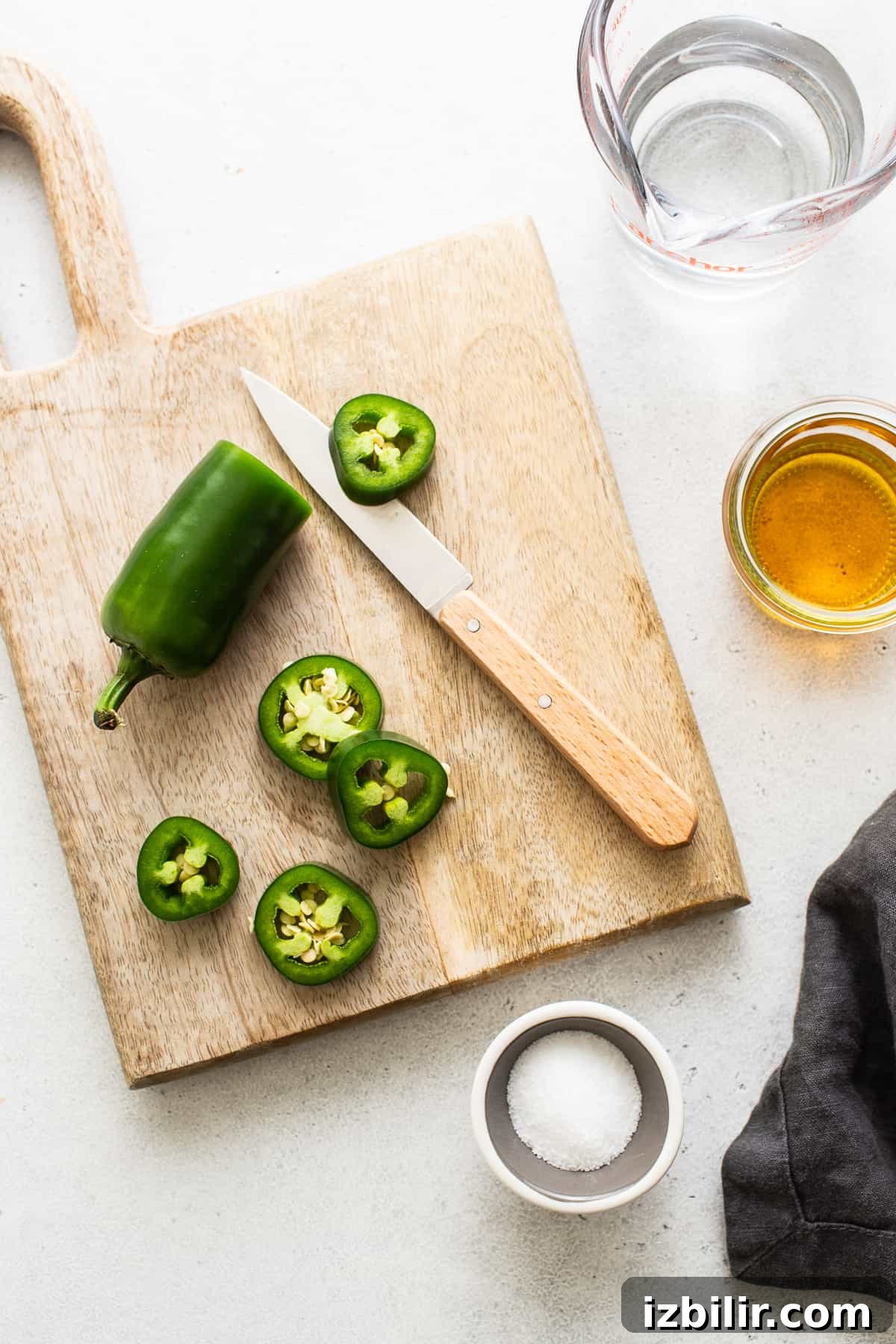 Sliced jalapeno on a cutting board.
