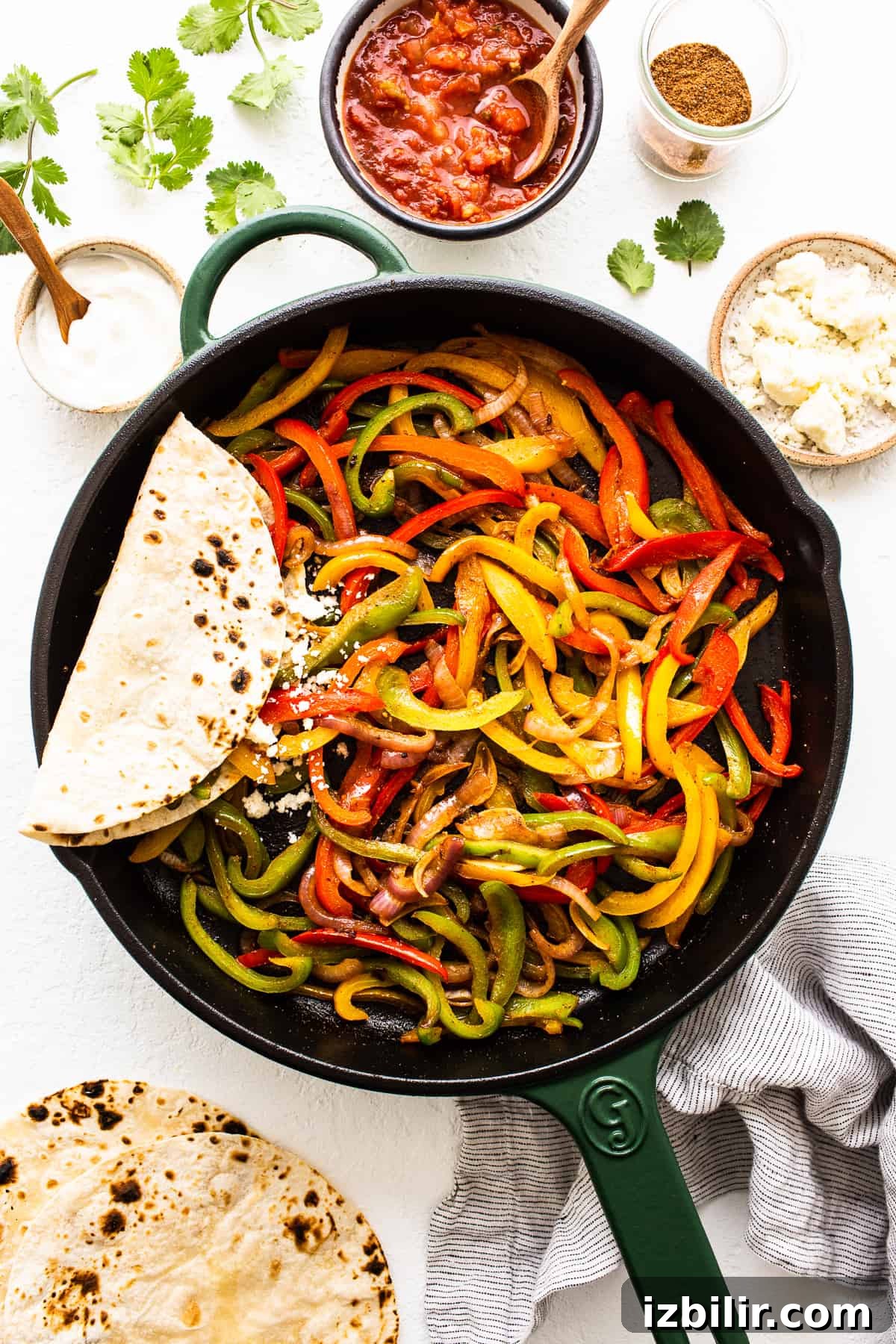Fajita veggies in a cast iron pan. fajita veggies in cast iron pan.