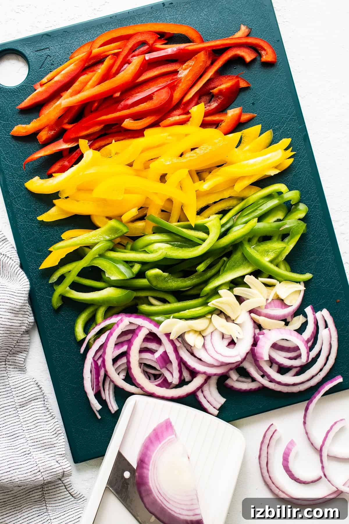 Sliced peppers and onions ready to cook. peppers and onions on cutting board.
