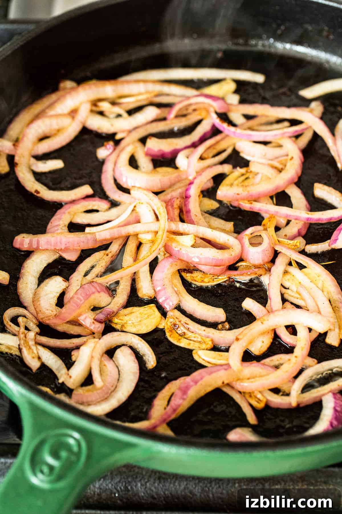 Onions and peppers cooking in a skillet. cooking onions in pan.