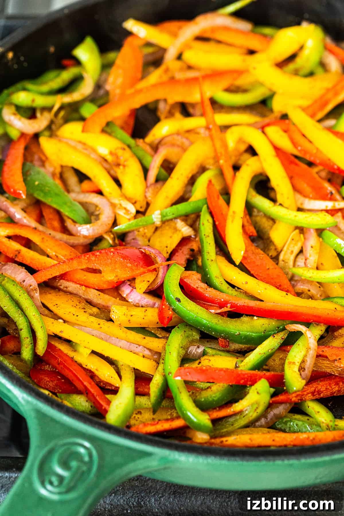 Peppers and onions in a cast iron pan. cooking peppers and onions in cast iron pan.
