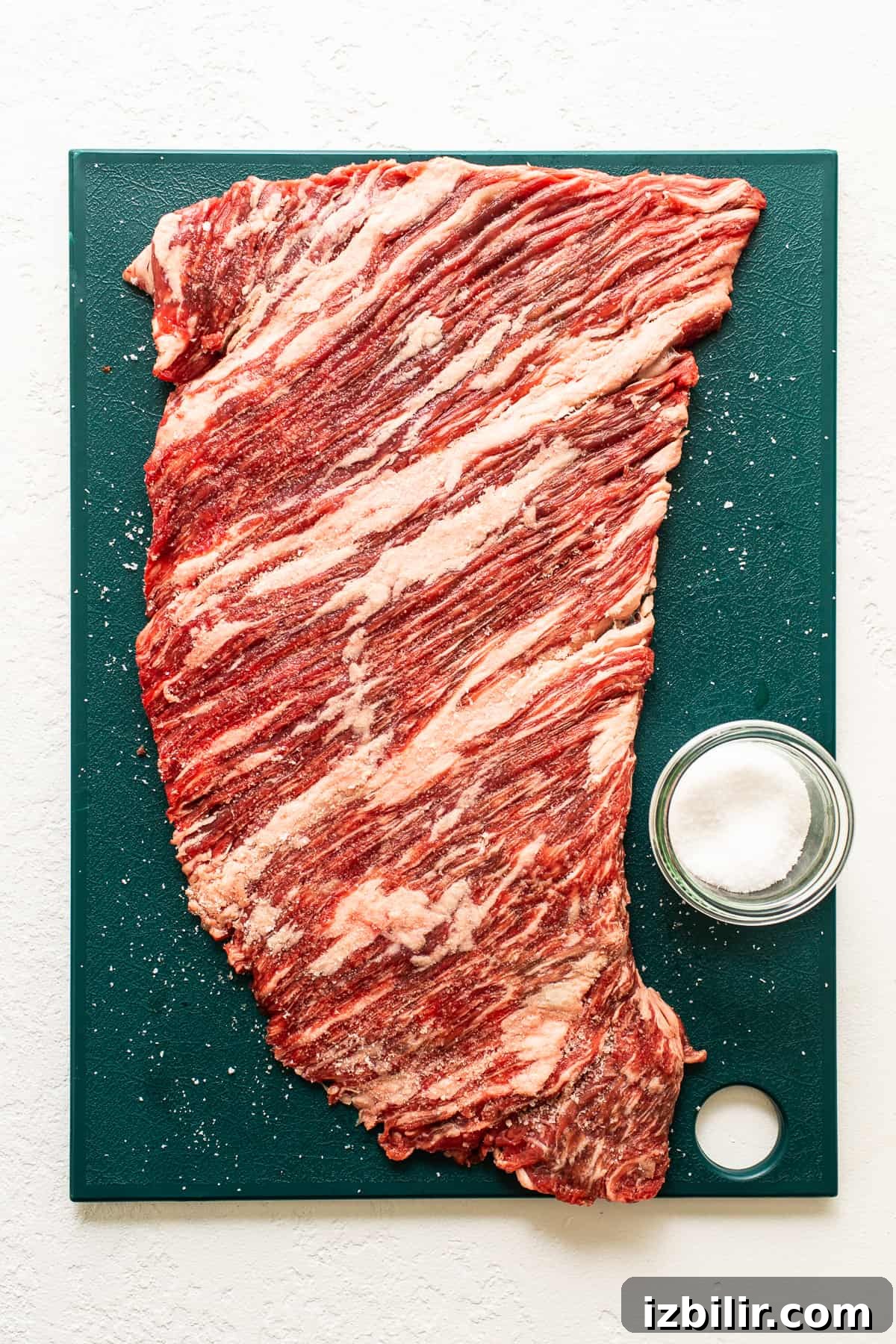 Flank steak on a cutting board.