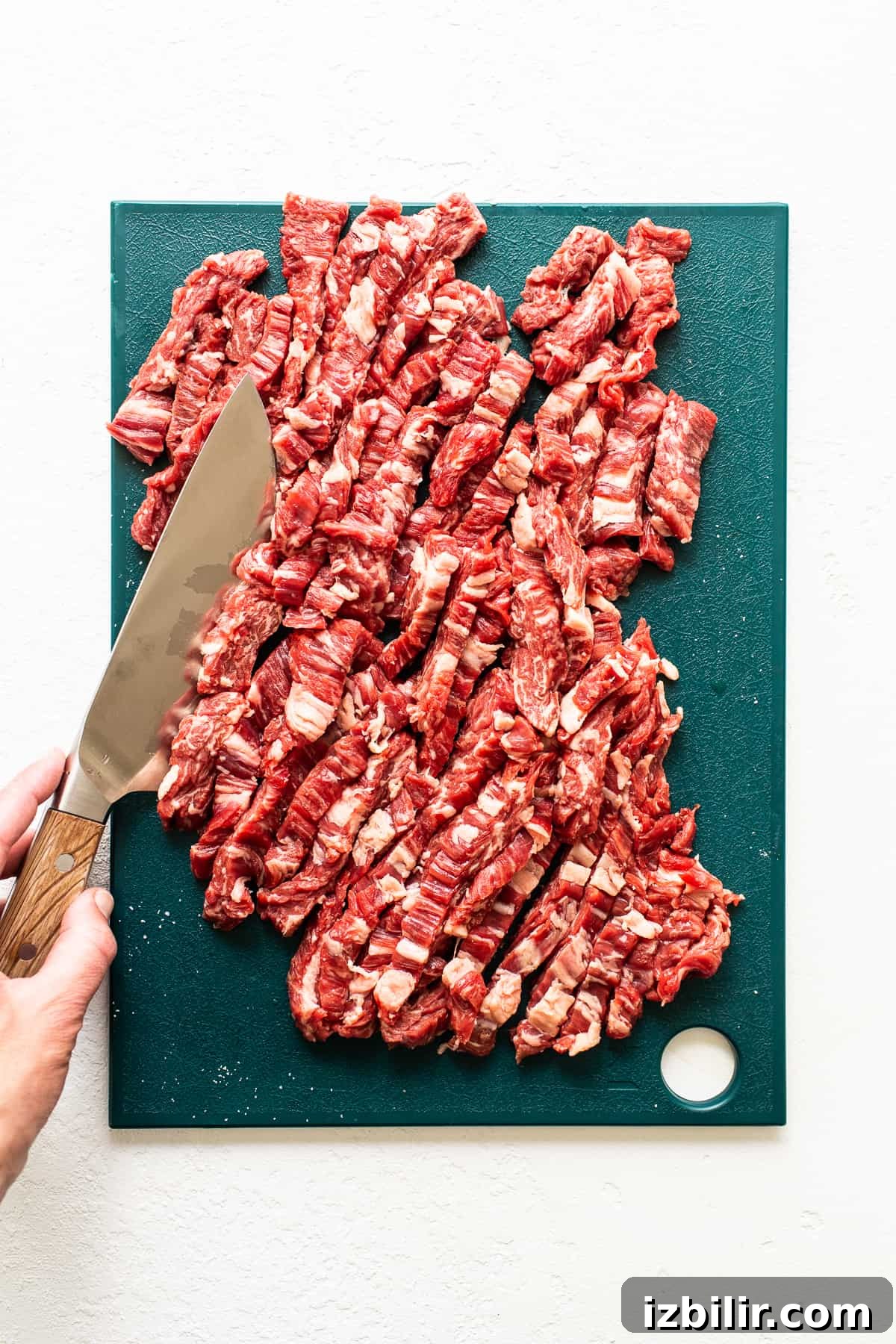 Sliced flank steak on a cutting board.
