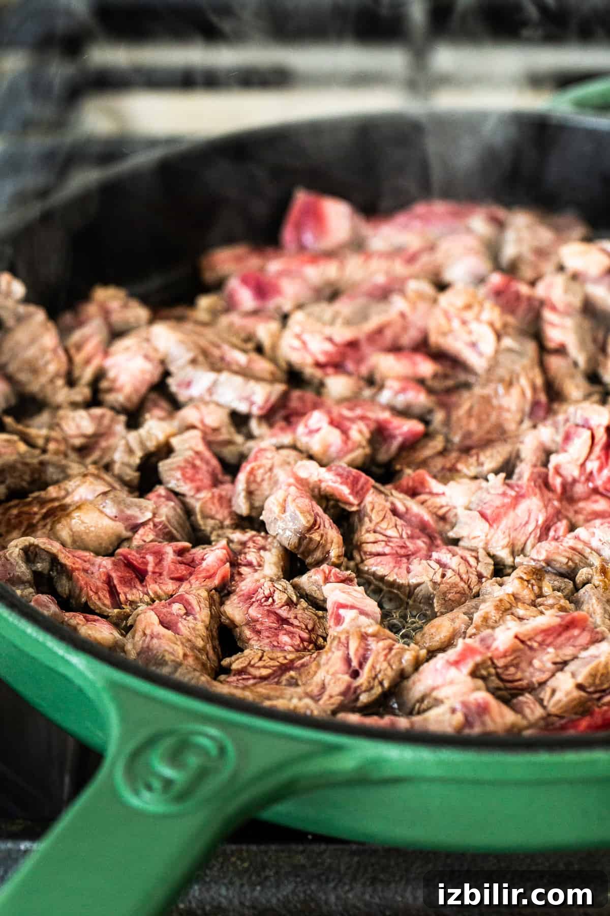 Flank steak in a cast iron skillet.
