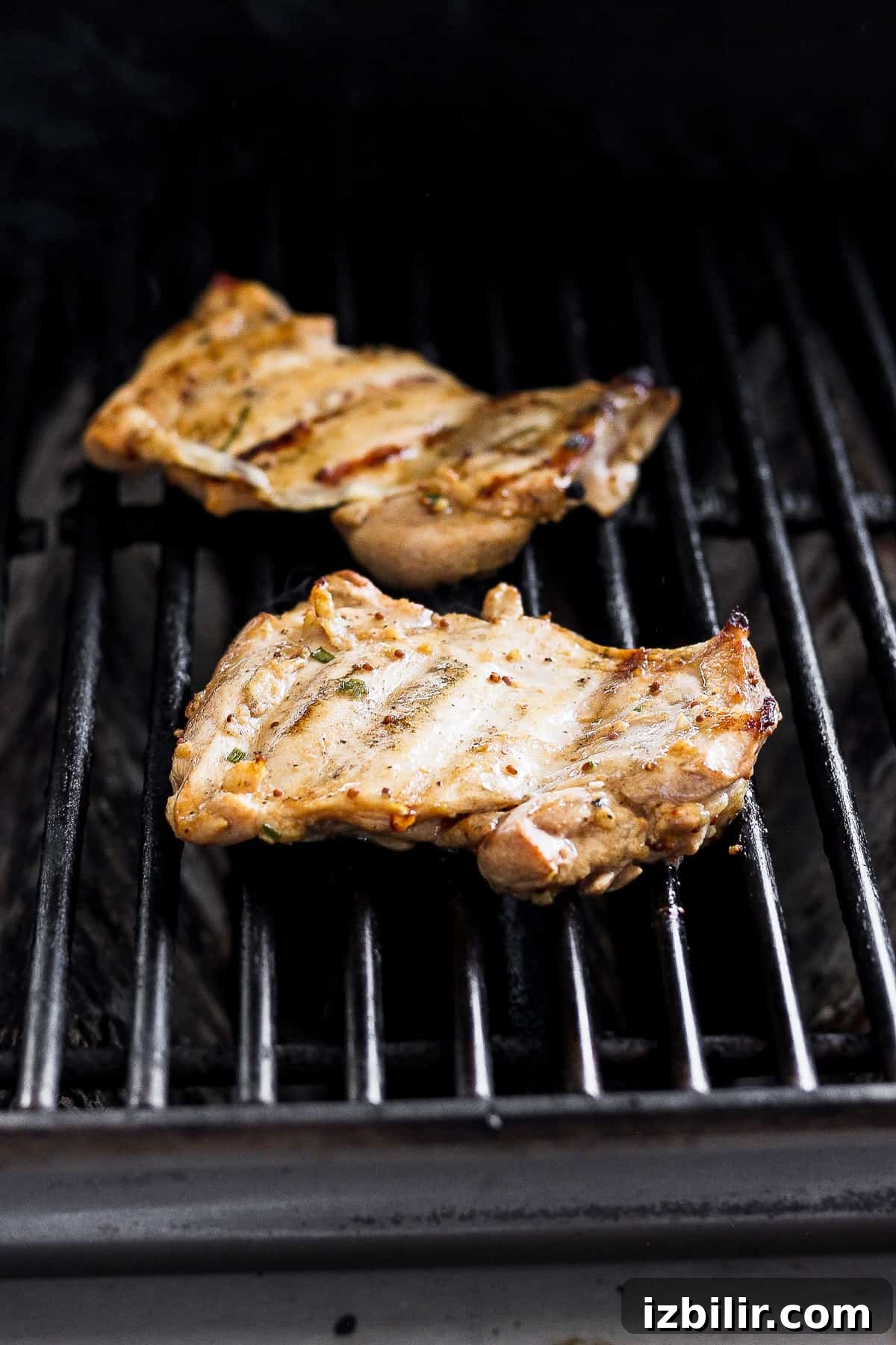 Grill boneless chicken thighs until charred and cooked through. Boneless skinless chicken thighs on grill grates.