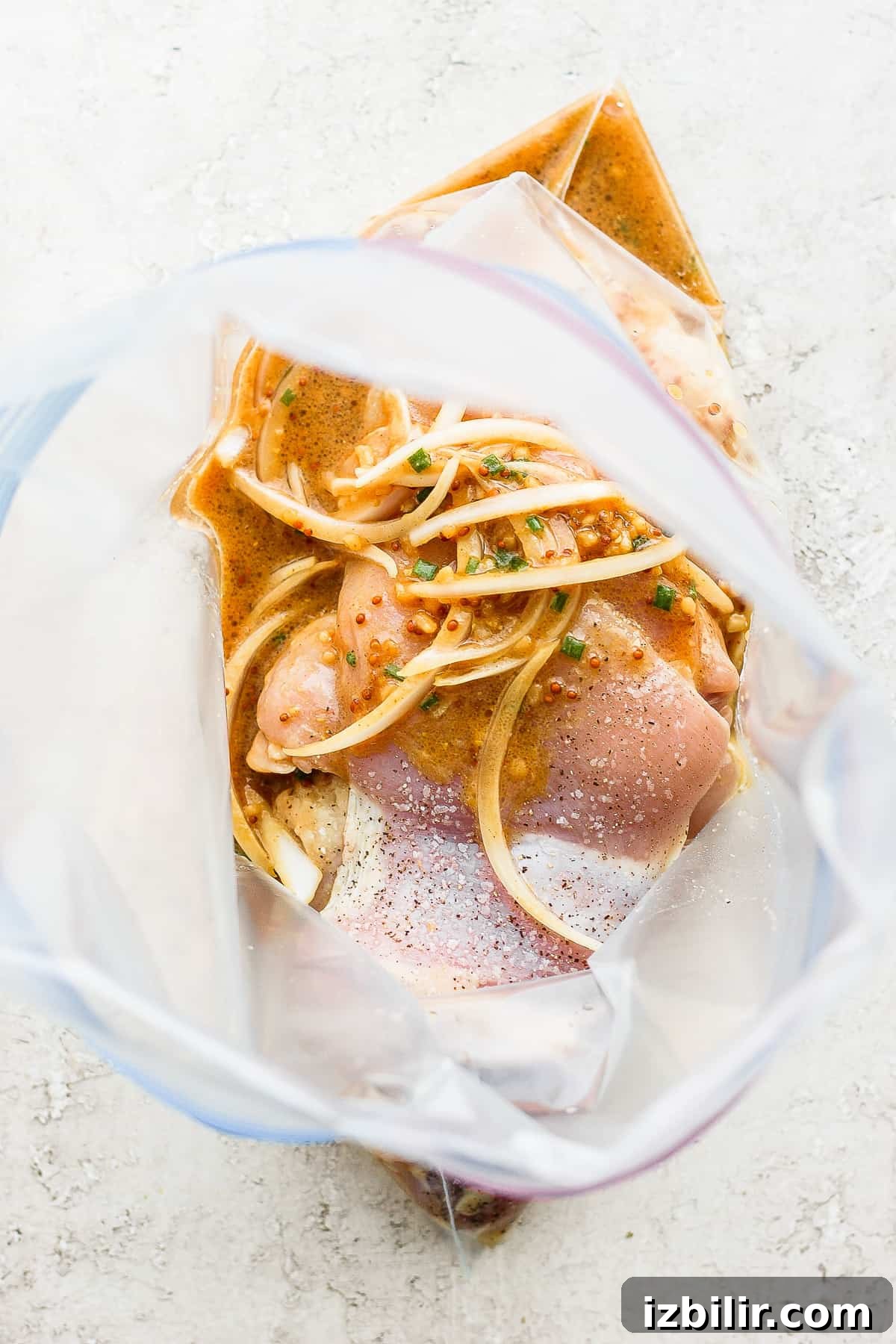 Chicken marinating in honey mustard sauce. Marinating chicken in sauce.