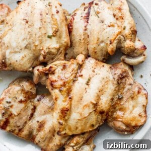 Savory Marinade for Juicy Chicken Thighs 3 chicken thighs on plate.