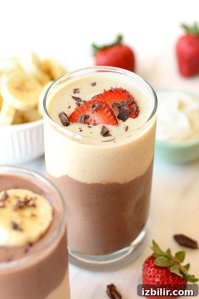 Layered Chocolate Banana Protein Smoothie Smoothie with strawberries on top