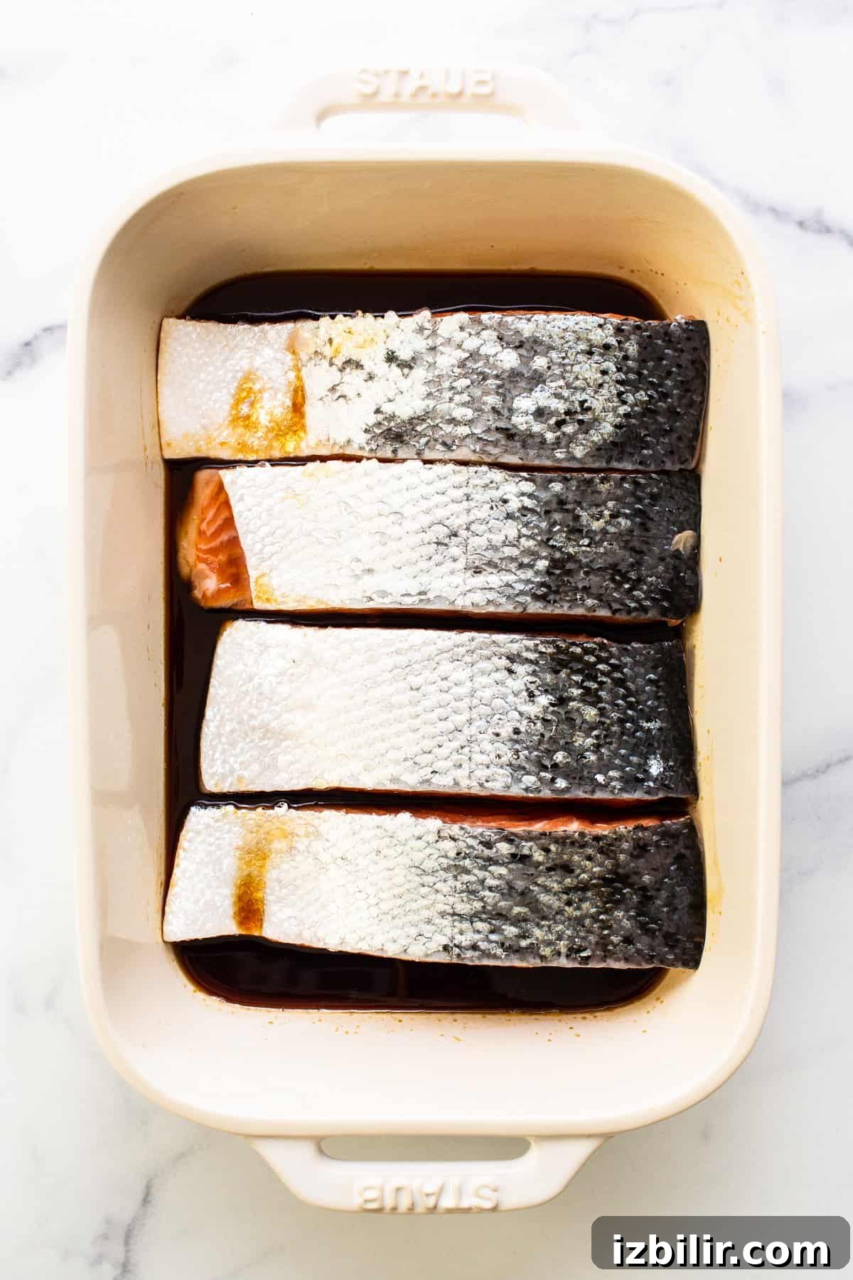 salmon marinating in dish.