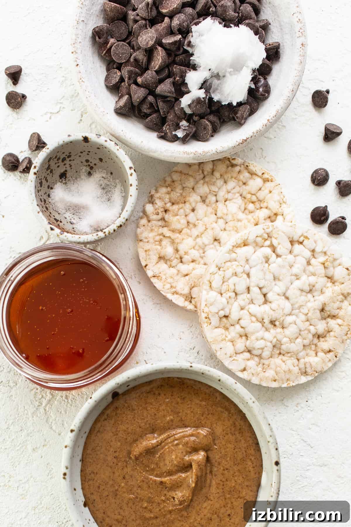 No-Bake Rice Cake Magic Bars Recipe with Chocolate and Nuts 3 A bowl of peanut butter, chocolate chips, and other ingredients.