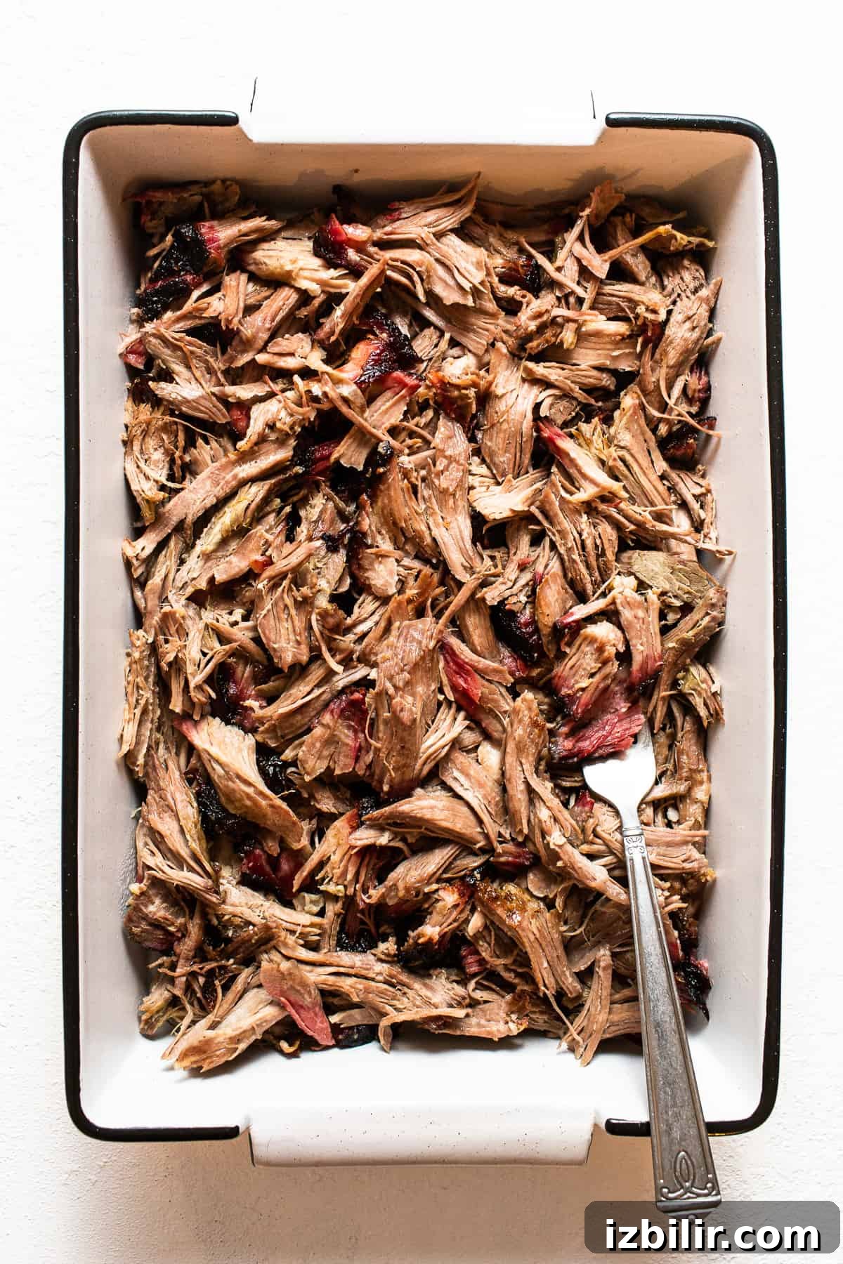 How to Smoke Pork Shoulder for Tender Pulled Pork 5 Shredded pork shoulder in a dish.
