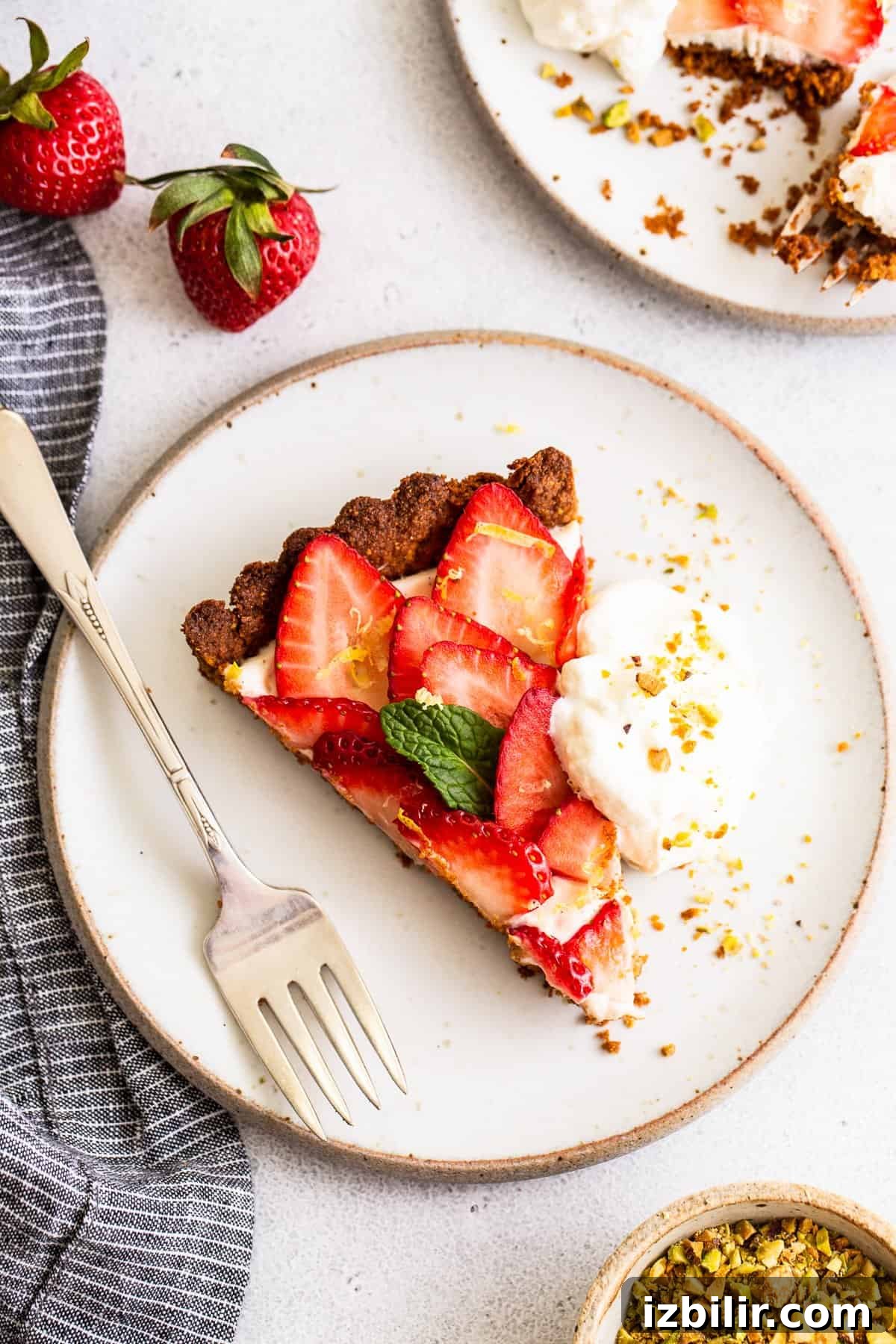 Whole strawberry tart on a white surface