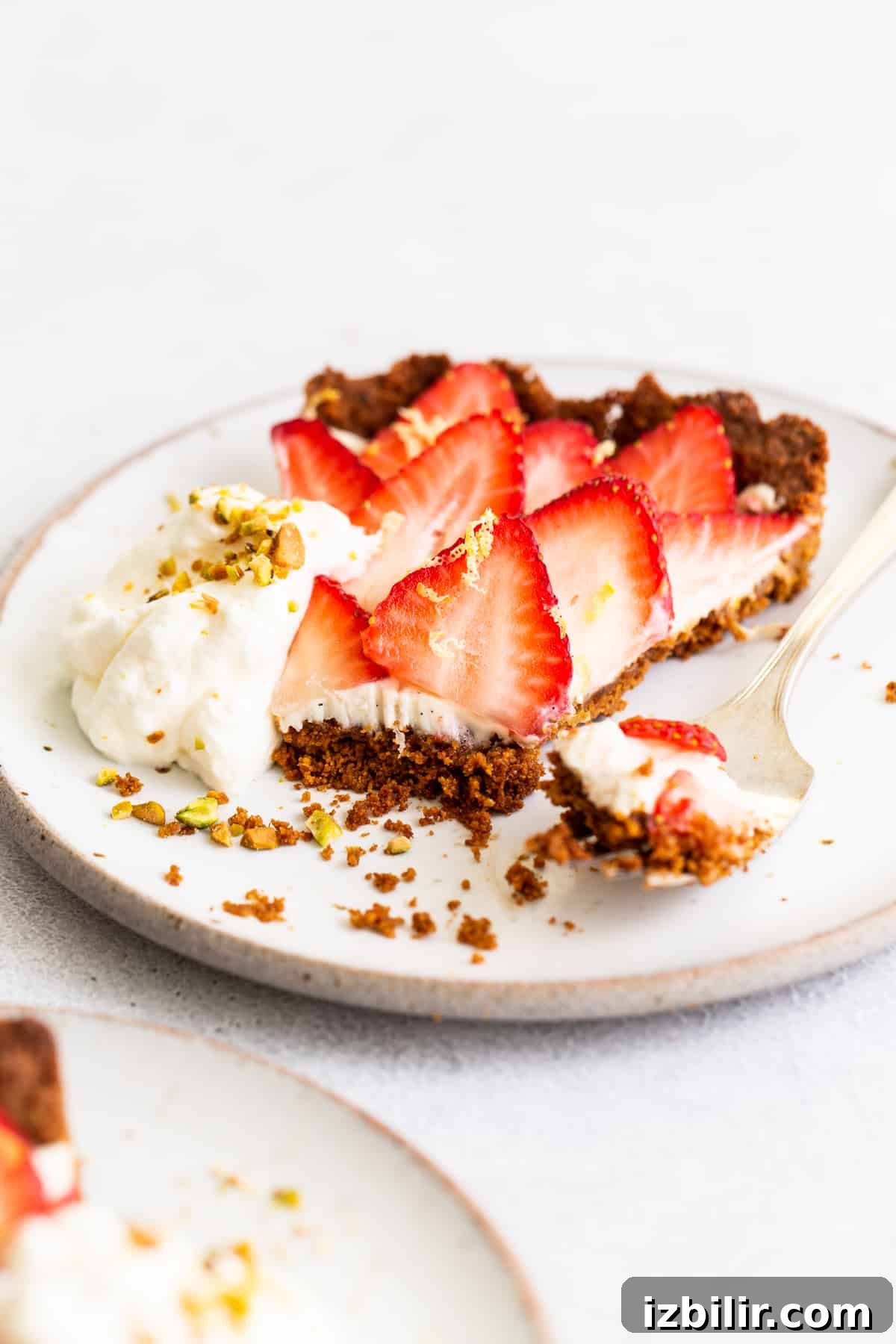 Tart slice on a plate with strawberries and mint