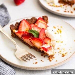 Slice of strawberry tart with whipped cream