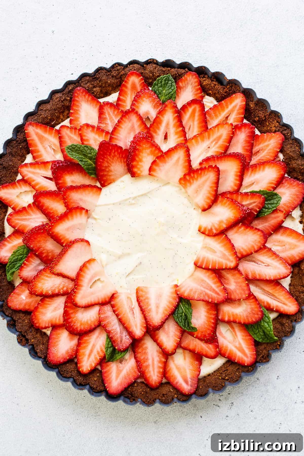 Strawberry tart on a table with a slice removed