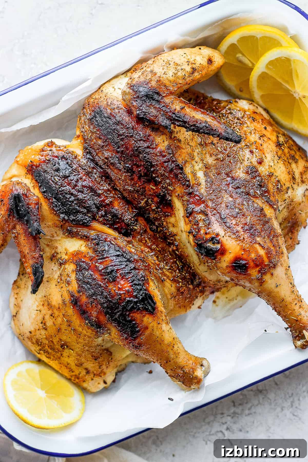 cooked whole chicken on platter.